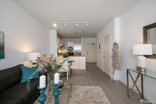 a living room with furniture potted plant and a chandelier
