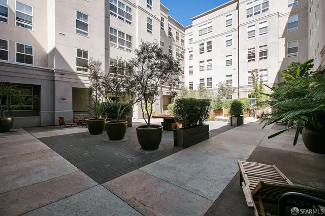 a view of a patio with couches and potted plants