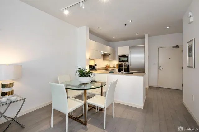 a kitchen with kitchen island white cabinets and stainless steel appliances