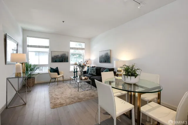 a living room with furniture and a potted plant