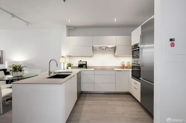 a kitchen with stainless steel appliances granite countertop a sink stove oven and refrigerator