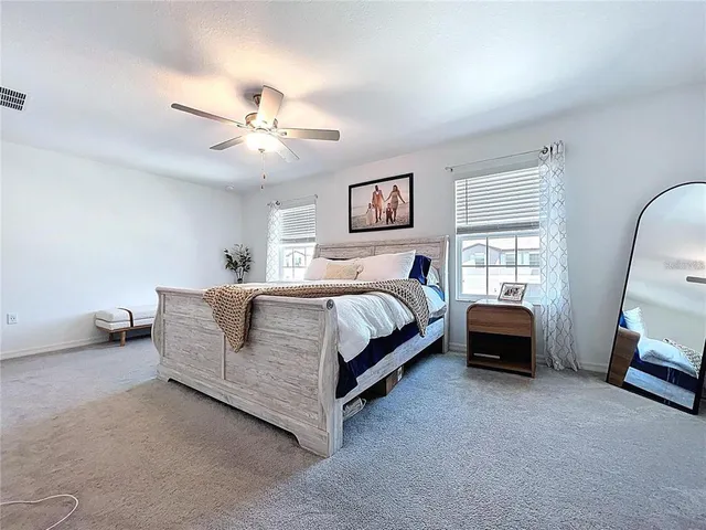 a bedroom with a bed and a couch