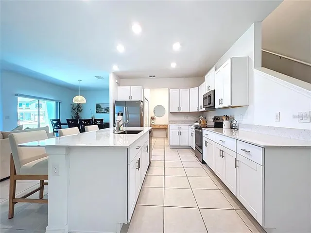a kitchen with stainless steel appliances kitchen island granite countertop a sink and cabinets