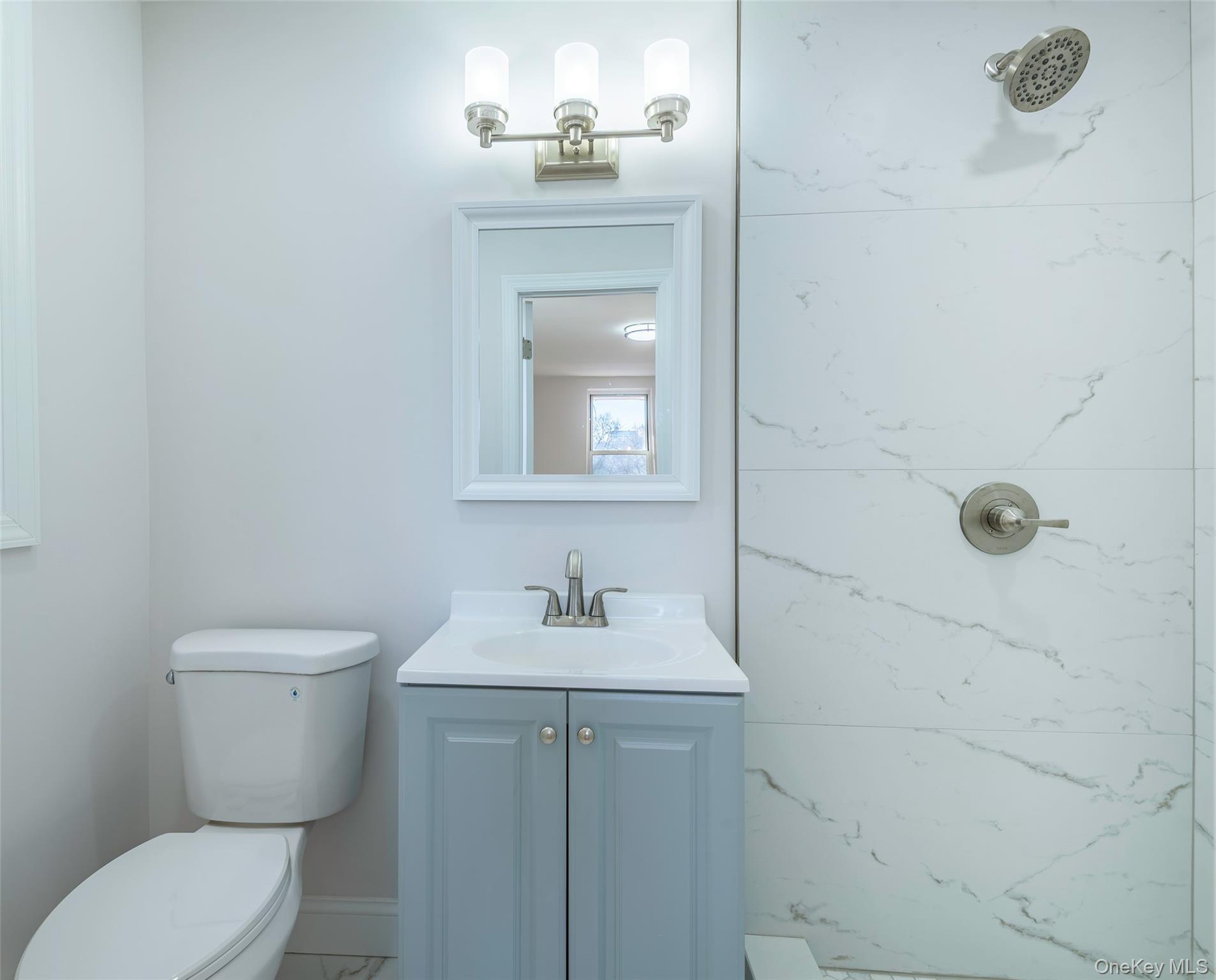 125 Bronx River Road, Unit 2E Yonkers, NY 10704 - Photo 15 of 31 a bathroom with a toilet sink and mirror