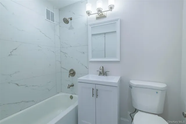 a bathroom with a toilet sink and bathtub