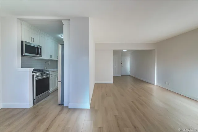 a view of a kitchen with a wooden floor and a stove top oven