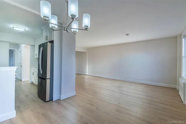 a view of a room with wooden floor and staircase