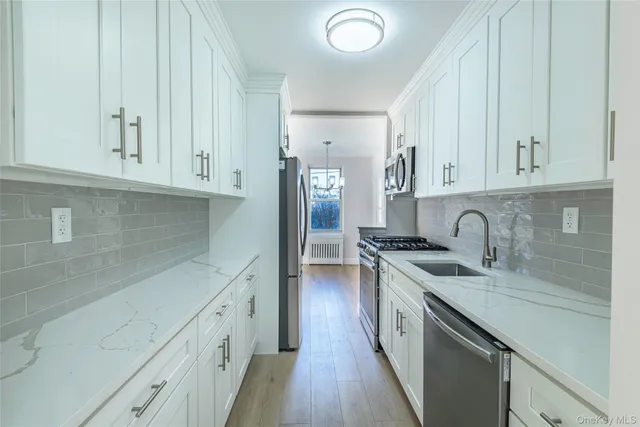 a kitchen with stainless steel appliances granite countertop a stove and a refrigerator