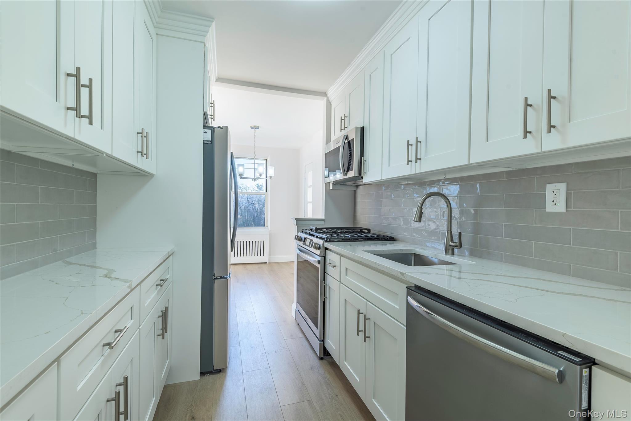 125 Bronx River Road, Unit 2E Yonkers, NY 10704 - Photo 9 of 31 a kitchen with stainless steel appliances granite countertop a sink stove and cabinets