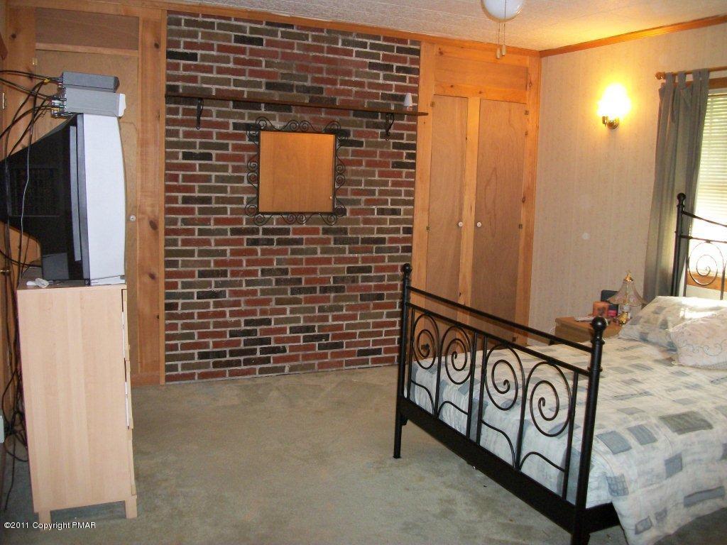 581 Wren Lane Bushkill, PA 18324 - Photo 8 of 16 a view of a brick wall with paintings on the wall