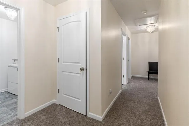 a view of a hallway with closet and wooden floor
