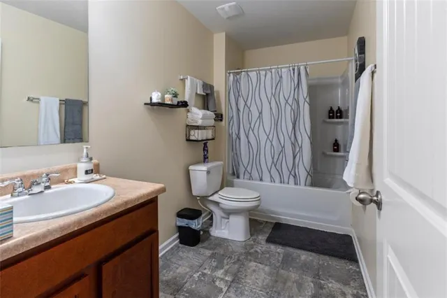 a bathroom with a toilet sink and shower