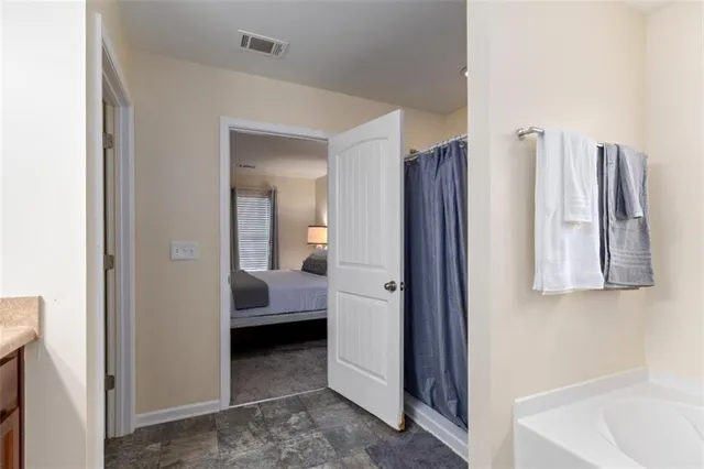 a en suite bathroom with a sink and a mirror