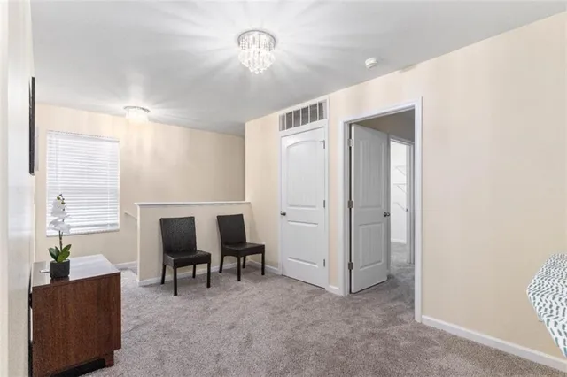 a view of a livingroom with furniture and a workspace