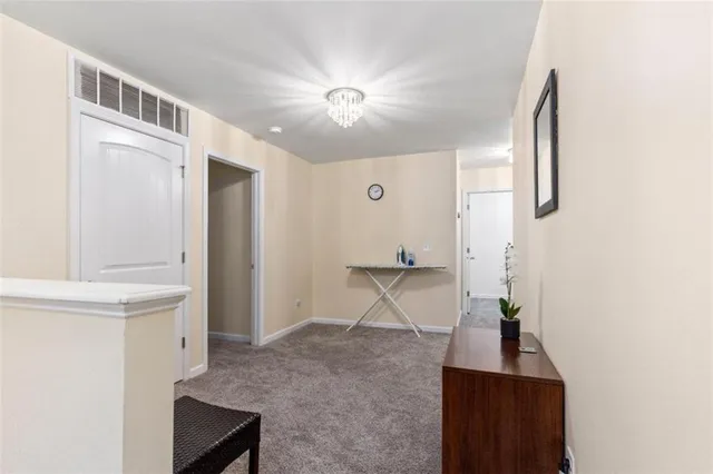 a view of a livingroom with wooden floor and staircase