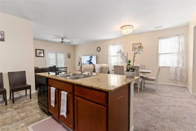 a view of kitchen island a sink and living room