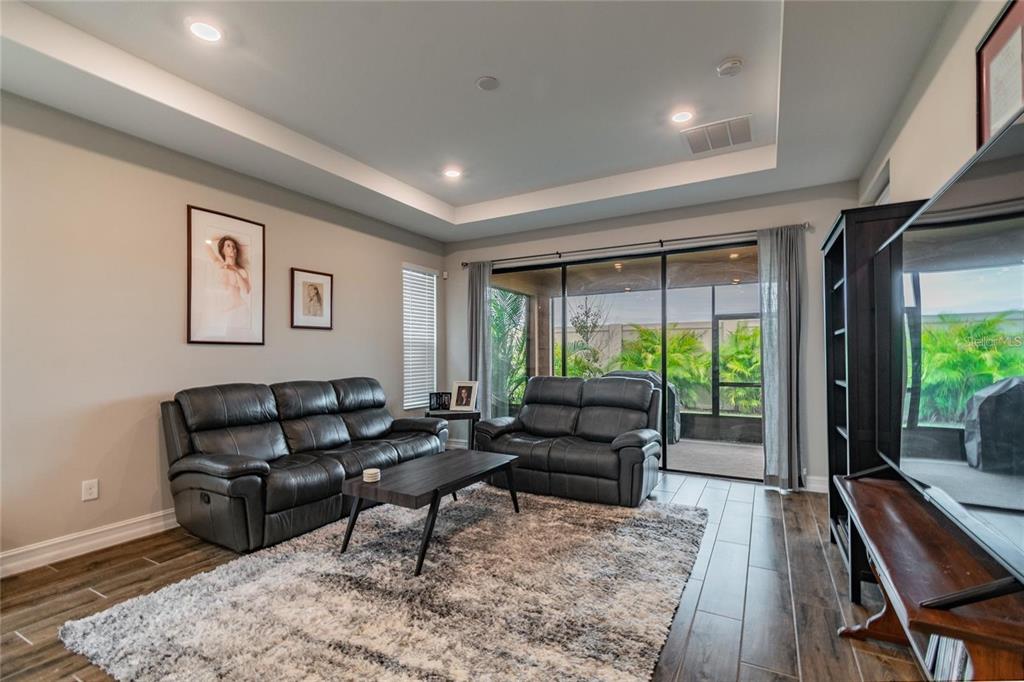 4738 Tramanto Lane Wesley Chapel, FL 33543 - Photo 16 of 45 a living room with furniture and a large window