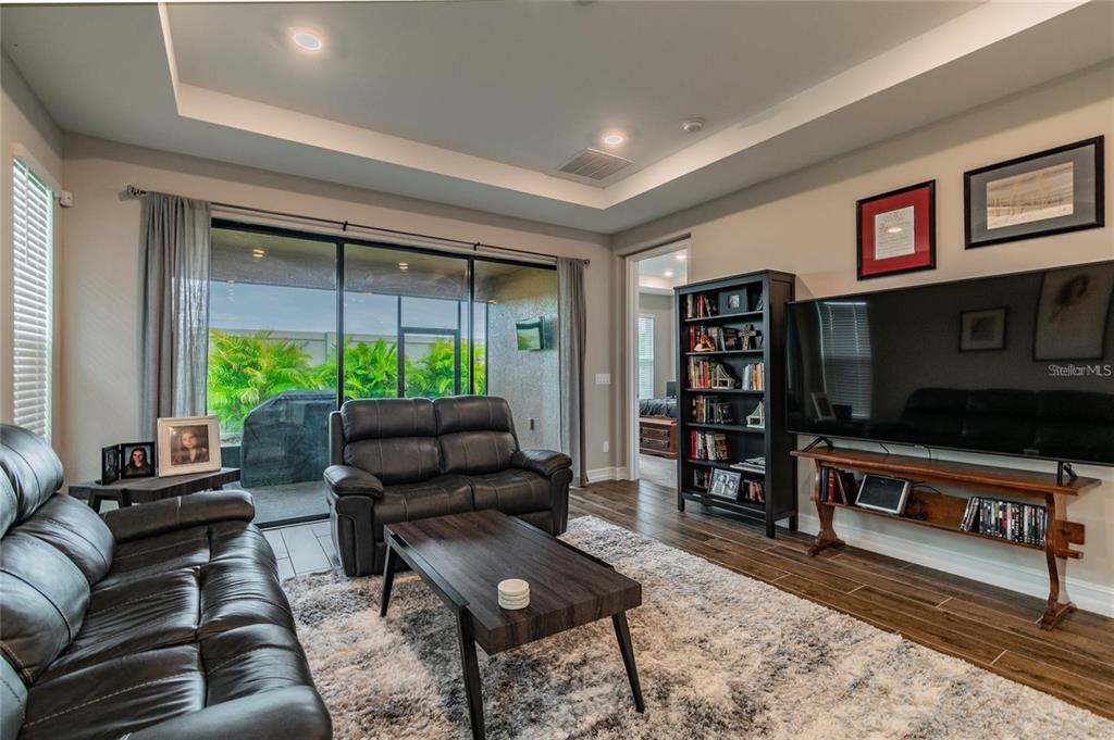 4738 Tramanto Lane Wesley Chapel, FL 33543 - Photo 17 of 45 a living room with furniture and a flat screen tv