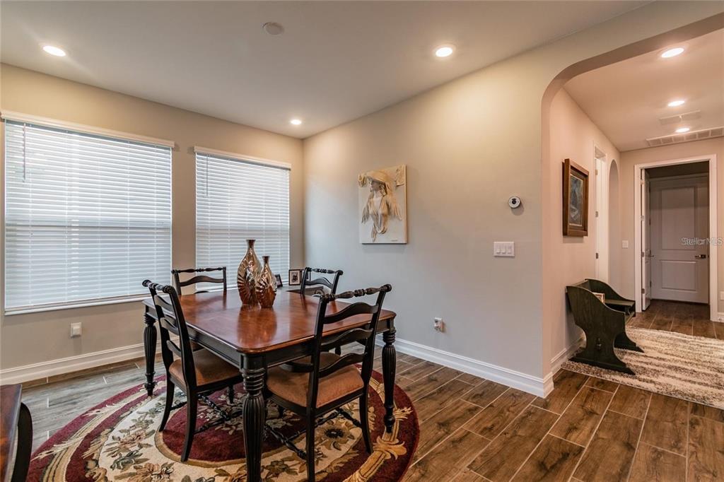 4738 Tramanto Lane Wesley Chapel, FL 33543 - Photo 20 of 45 a view of a dining room with furniture window and wooden floor