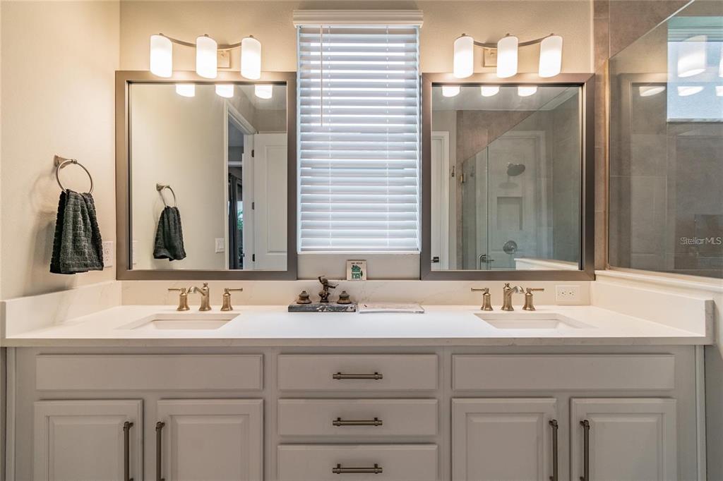 4738 Tramanto Lane Wesley Chapel, FL 33543 - Photo 26 of 45 a bathroom with double sink and a mirror