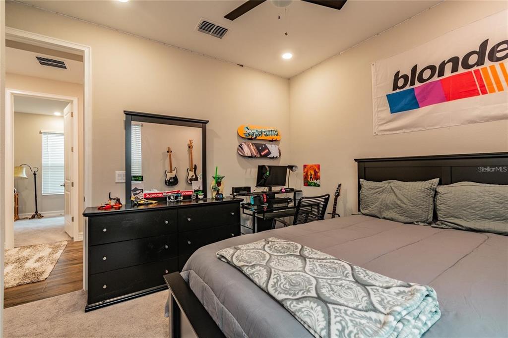 4738 Tramanto Lane Wesley Chapel, FL 33543 - Photo 31 of 45 a bedroom with a bed and a dresser