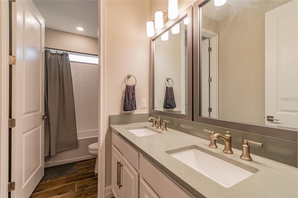 4738 Tramanto Lane Wesley Chapel, FL 33543 - Photo 32 of 45 a bathroom with double vanity sinks and a mirror