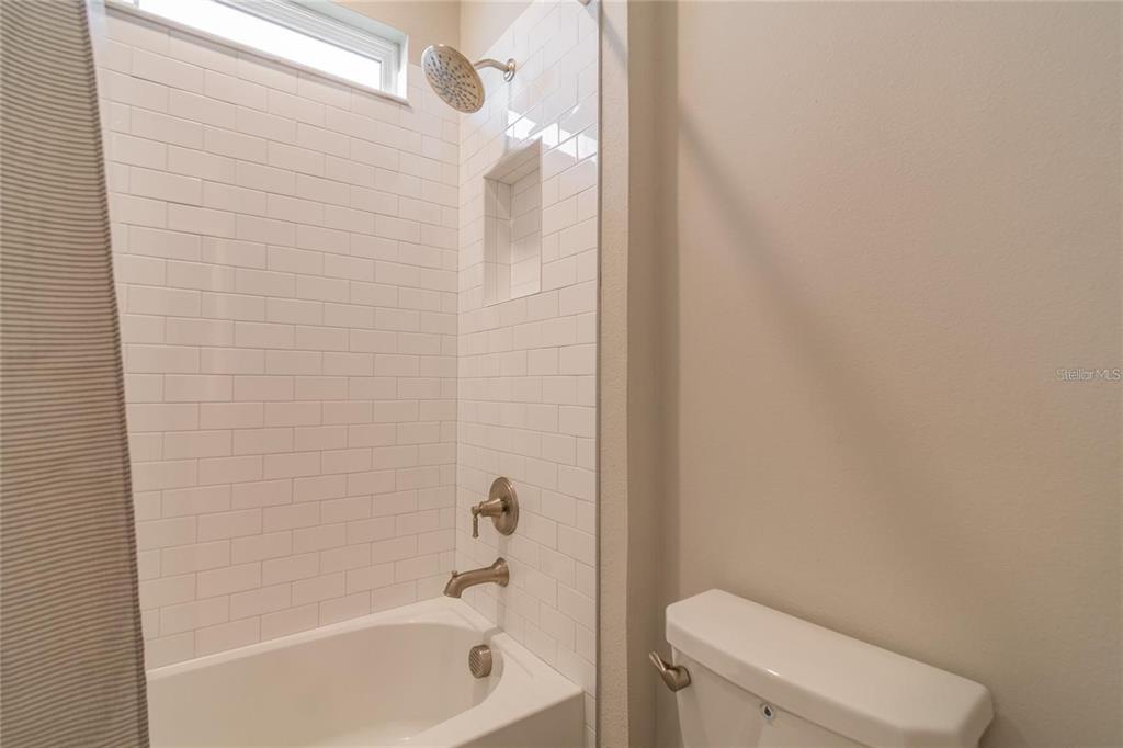 4738 Tramanto Lane Wesley Chapel, FL 33543 - Photo 33 of 45 a bathroom with a toilet and a bathtub