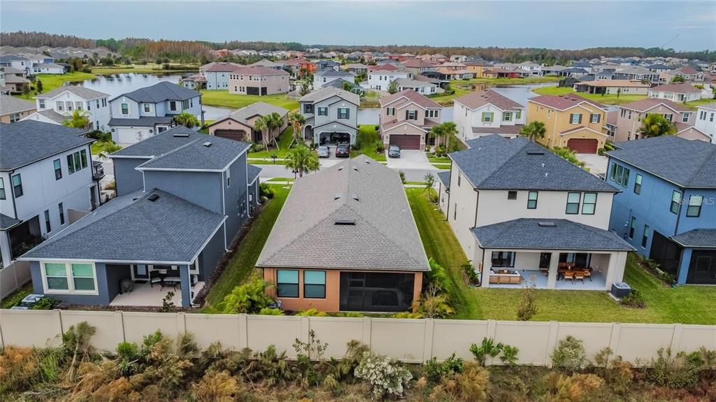 4738 Tramanto Lane Wesley Chapel, FL 33543 - Photo 44 of 45 an aerial view of a house with a garden
