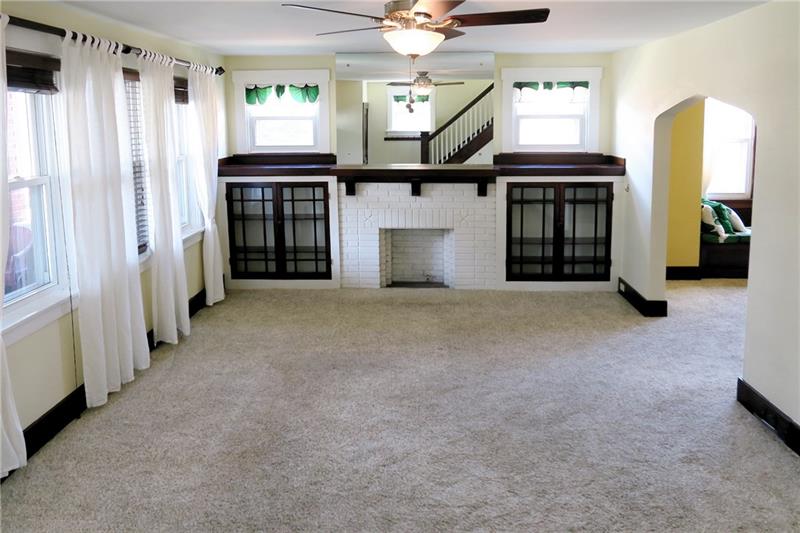 124 Ridgewood Avenue Pittsburgh, PA 15229 - Photo 3 of 21 Living Room: 14x21, original built-ins flank the decorative fireplace.