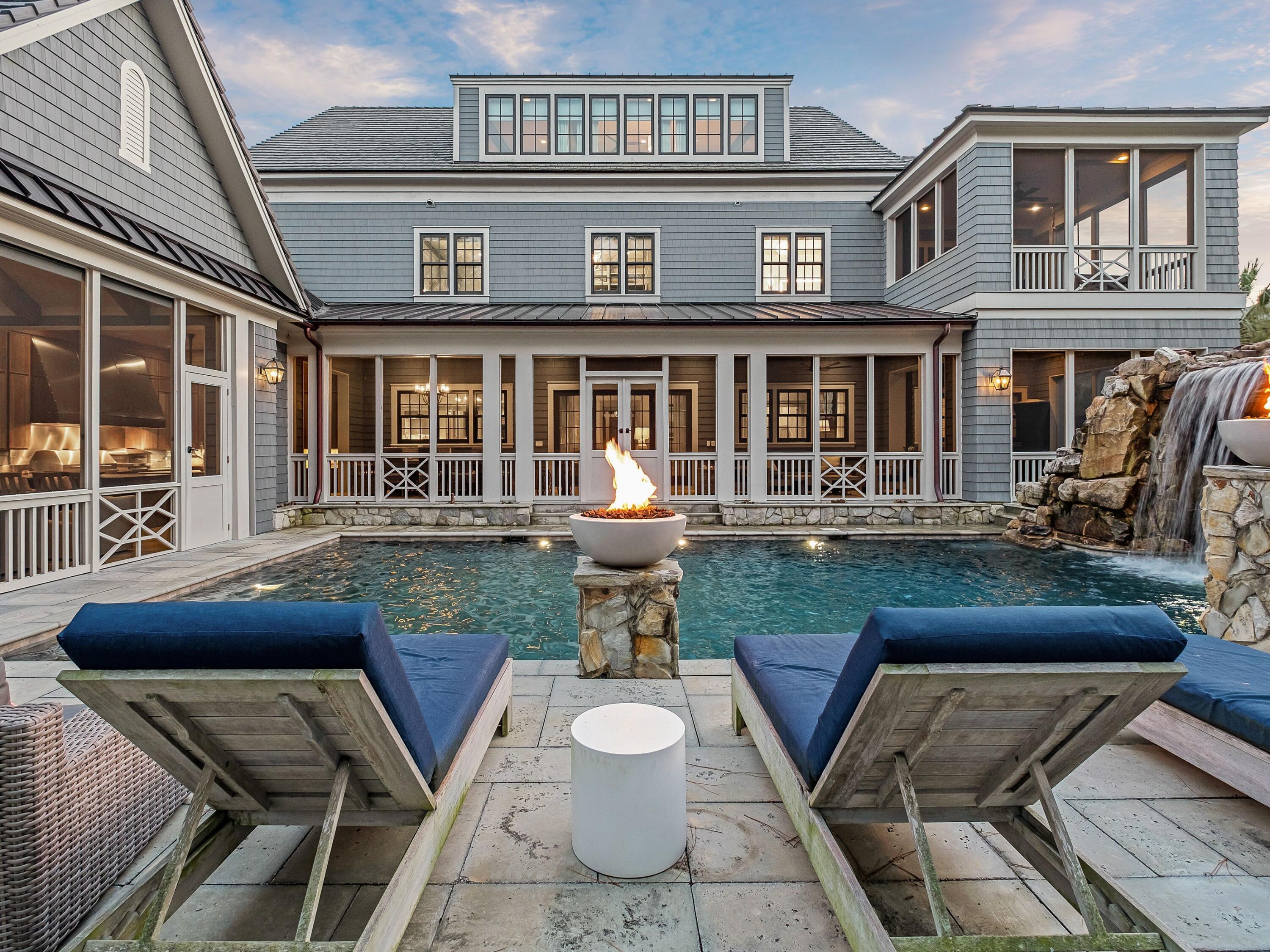 a front view of a house with a yard chairs and table