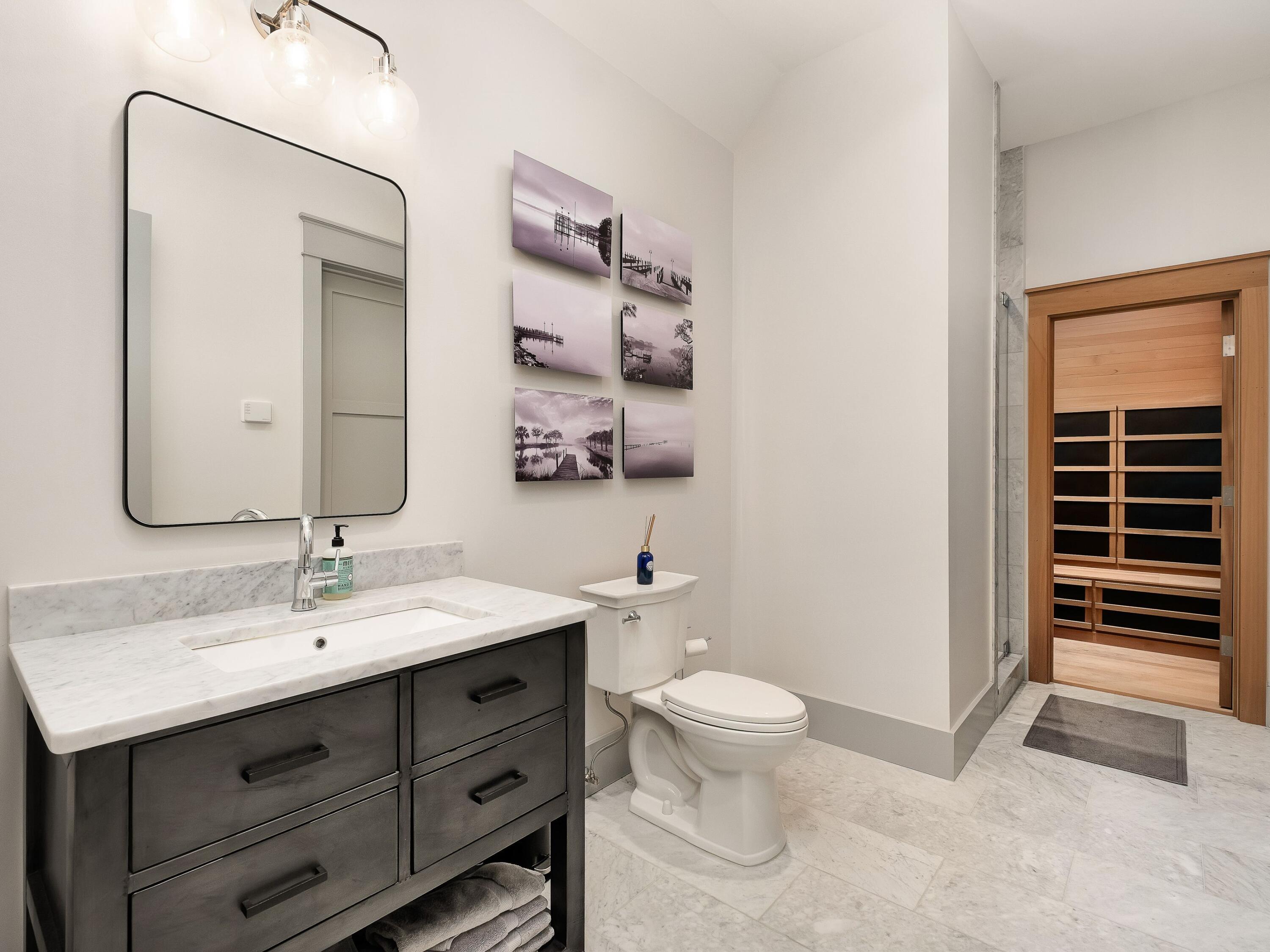 179 Brenda Ln Inlet Beach Inlet Beach, FL 32461 - Photo 38 of 63 a bathroom with a toilet sink and mirror