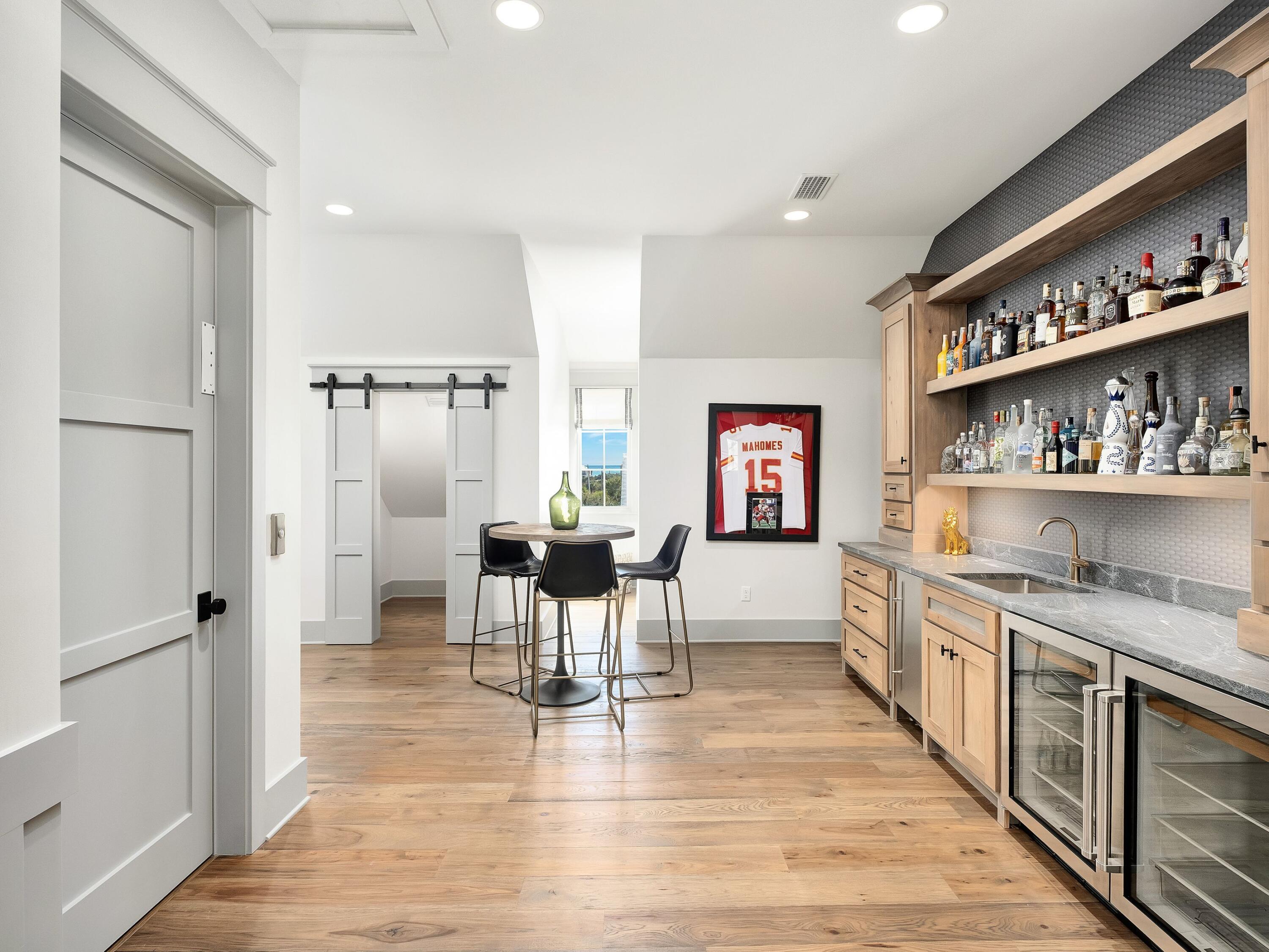 179 Brenda Ln Inlet Beach Inlet Beach, FL 32461 - Photo 54 of 63 a kitchen with stainless steel appliances granite countertop a refrigerator and wooden floor