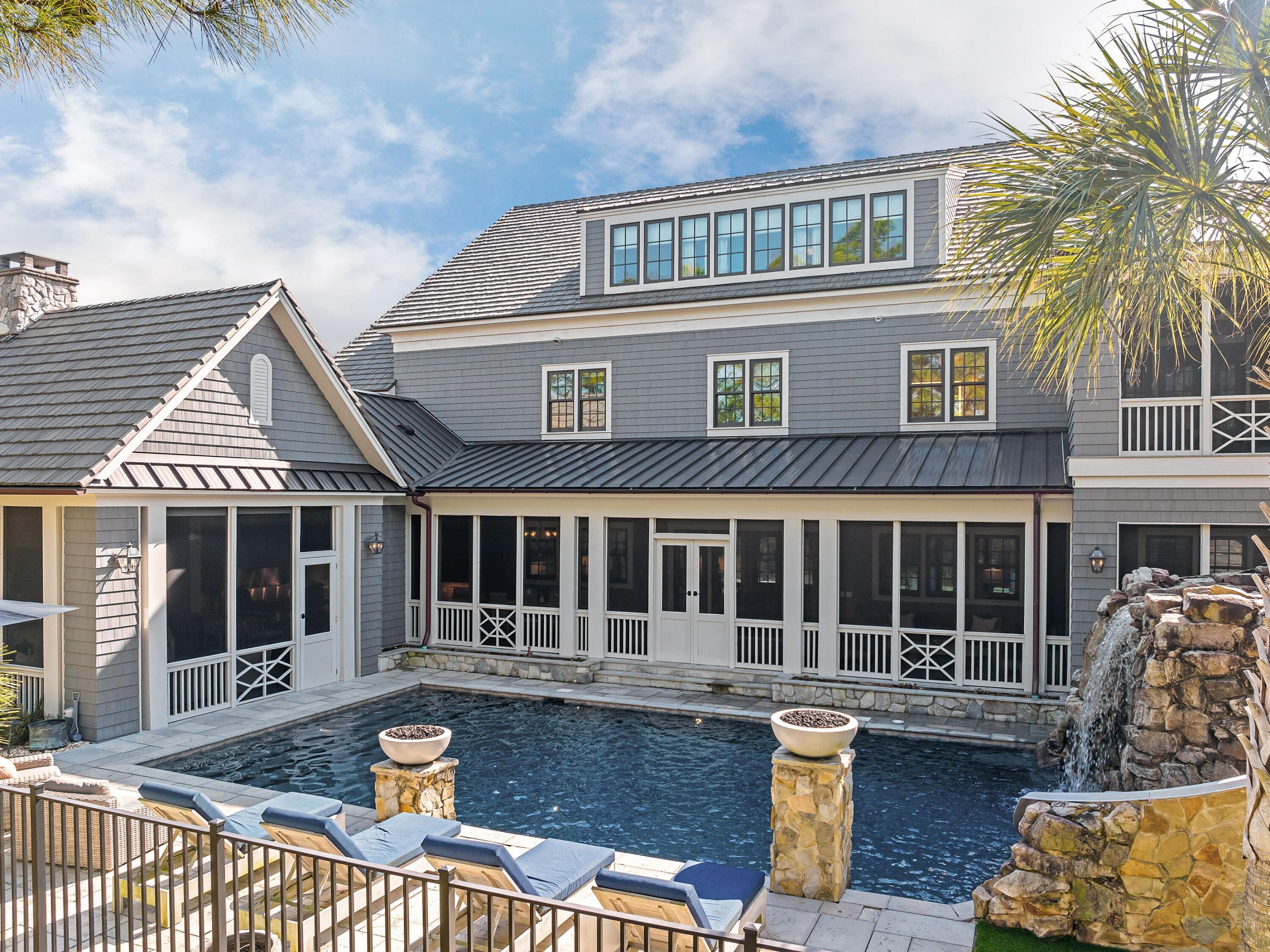 179 Brenda Ln Inlet Beach Inlet Beach, FL 32461 - Photo 59 of 63 a front view of a house with a yard glass top table and chairs