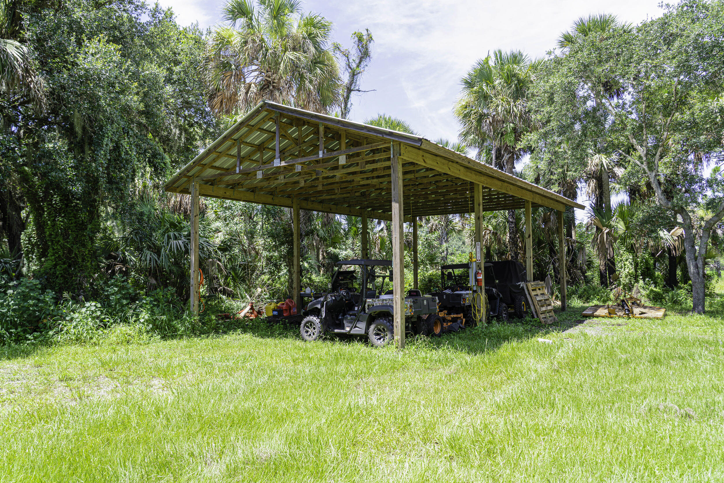 4902 Southwest Wild Turkey Lane Okeechobee, FL 34974 - Photo 11 of 17 a view of a chair and table in the garden