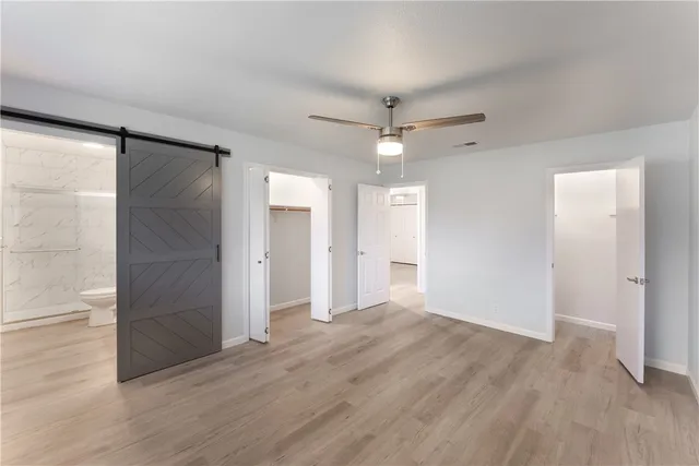 wooden floor in an empty room with a bathroom