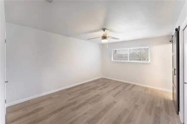 wooden floor in an empty room with a bathroom