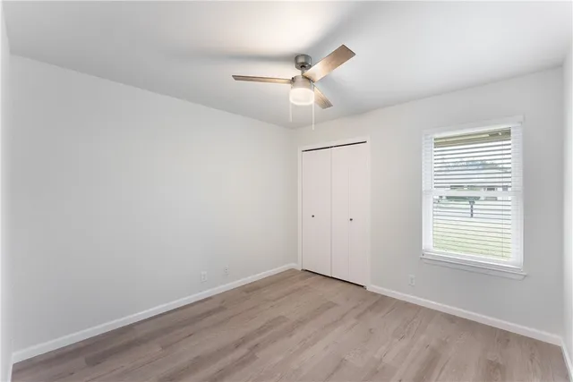 wooden floor in an empty room with a window