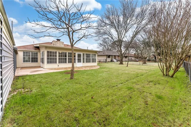 a front view of a building with a yard