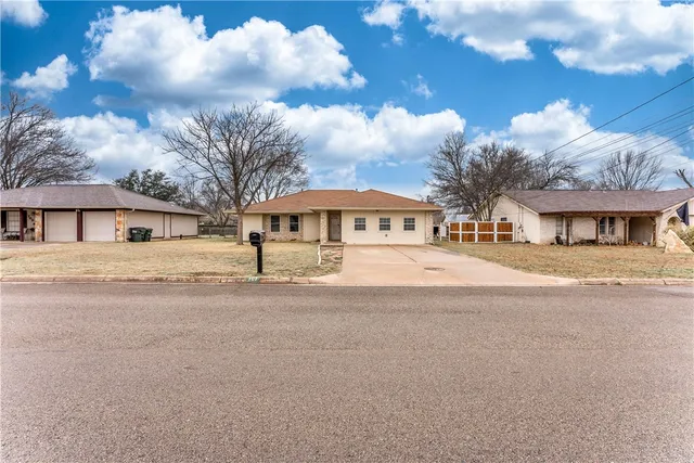 a front view of house with a garden