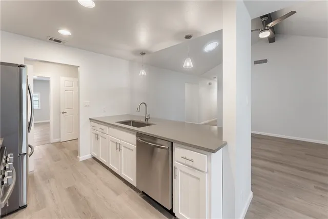 a kitchen with a sink and cabinets