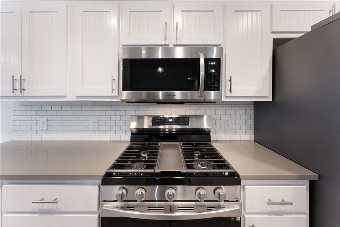 707 Central Drive Georgetown, TX 78628 - Photo 10 of 30 a stove top oven sitting inside of a kitchen