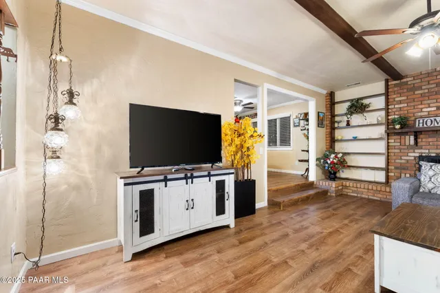 a large kitchen with cabinets chairs and chandelier