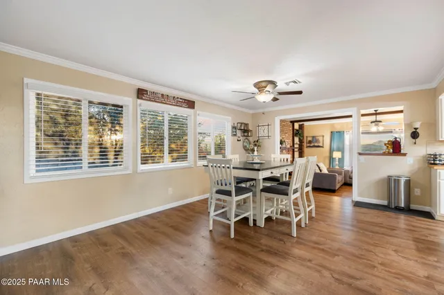 a living room with furniture pool table and window