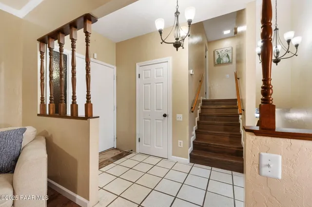 a spacious bedroom with a bed and a chandelier