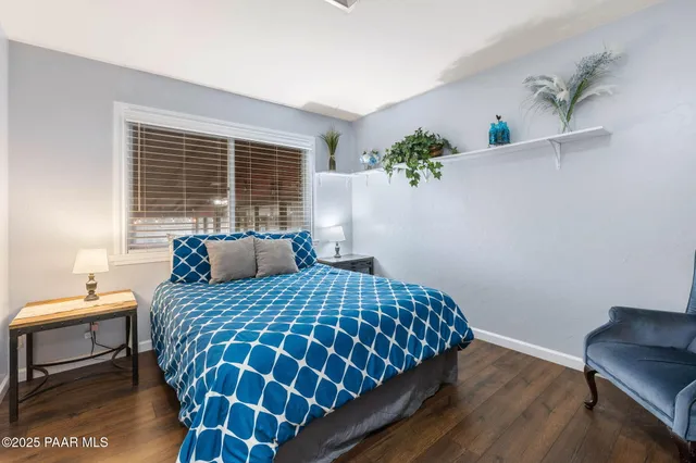 an aerial view of houses with a street and green space