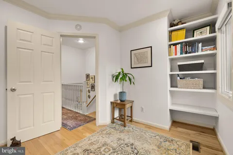 a bedroom with a bed dresser and window