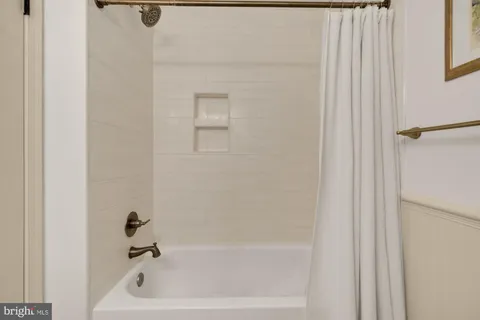 a living room with furniture and a book shelf