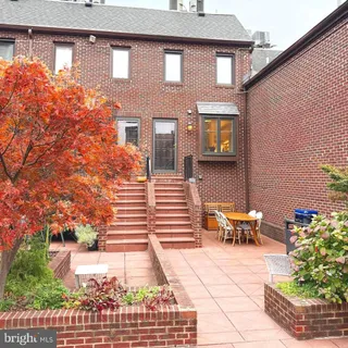 a front view of a house with outdoor seating