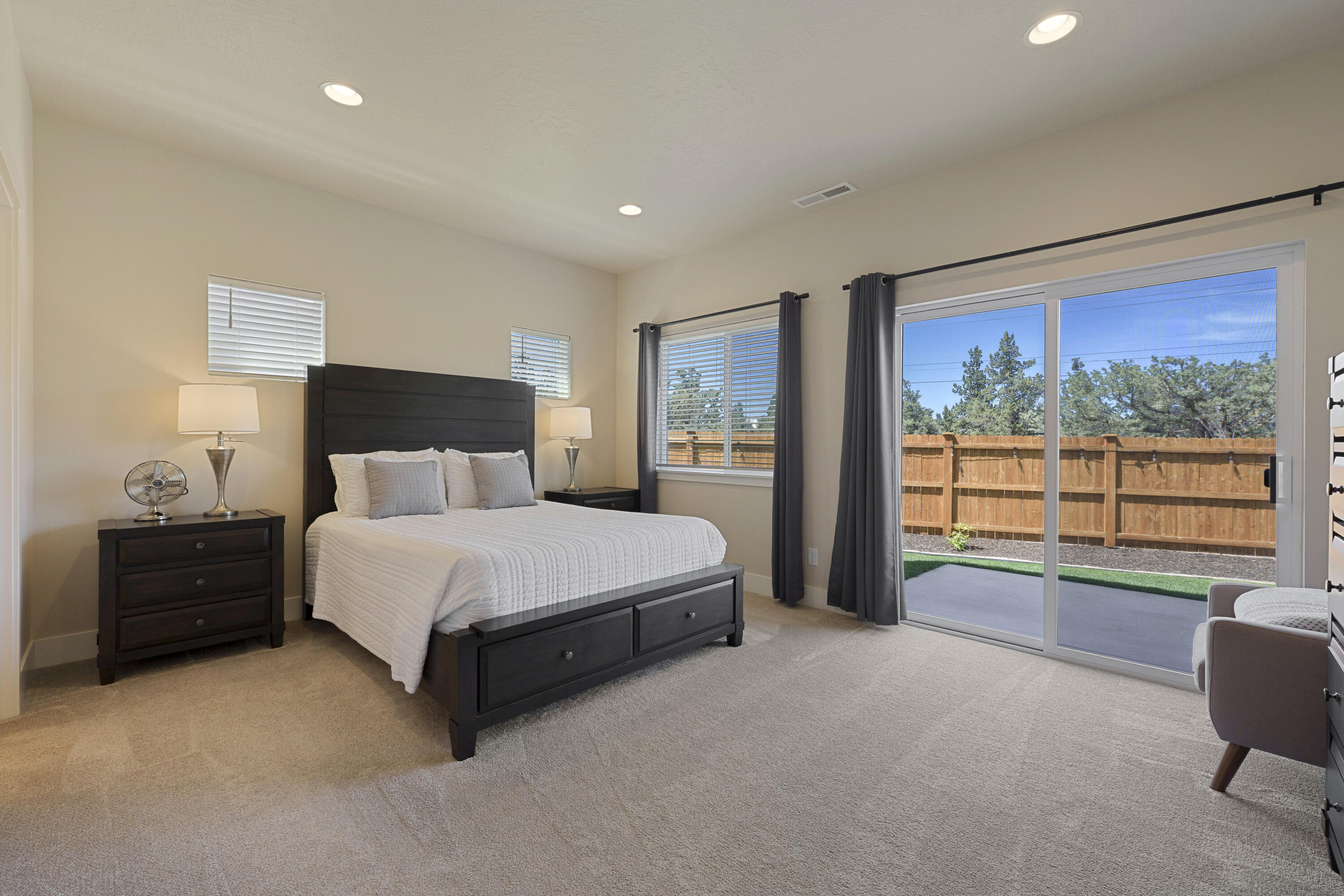 4999 Southwest Yew Place Redmond, OR 97756 - Photo 21 of 50 a spacious bedroom with a large bed and a large window