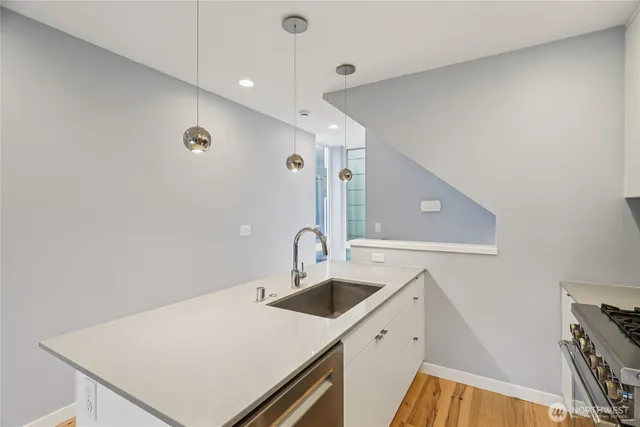 a kitchen with a sink a refrigerator and a stove